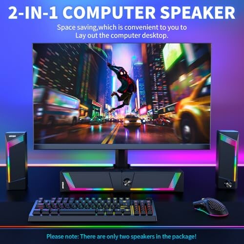 RGB computer speakers with monitor, keyboard, and mouse on a desk.