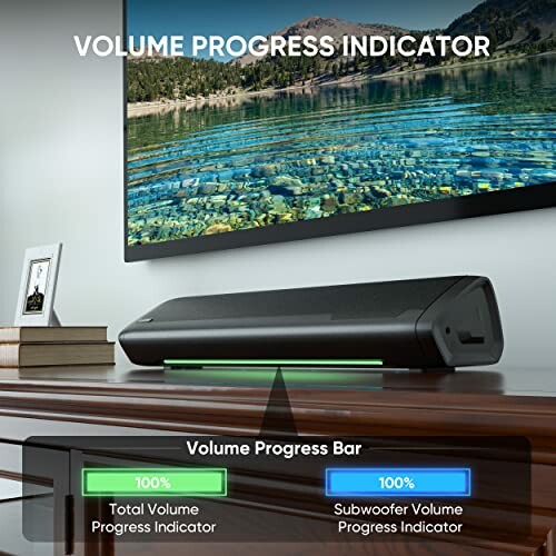 Soundbar with volume progress indicator and TV on wooden table.